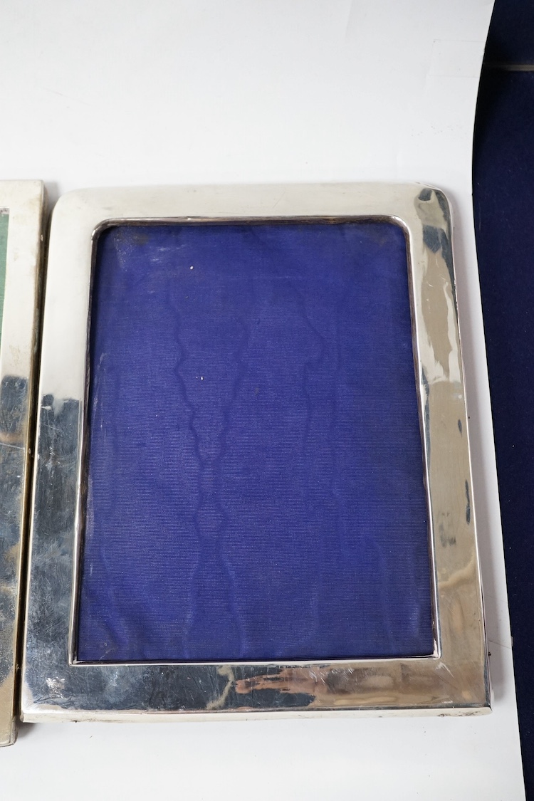 Three assorted early 20th century silver mounted photograph frames, including Birmingham, 1916, (some marks rubbed), largest 27cm. Condition - poor to fair